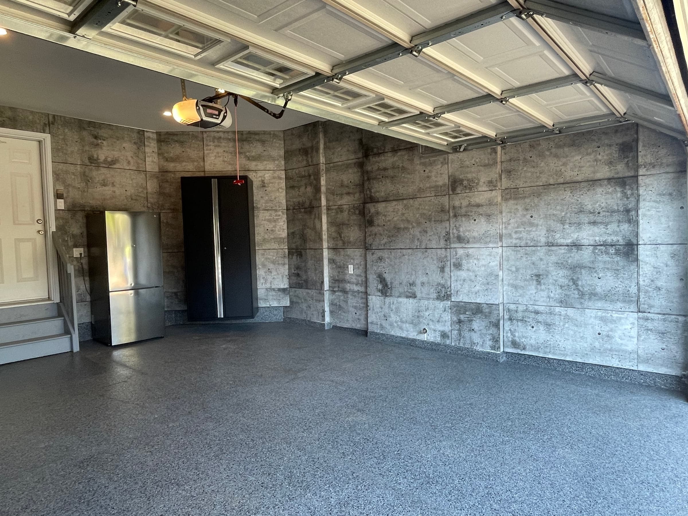 Finished garage floor and storage cabinetry viewed from the garage entrance